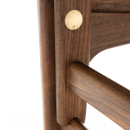 Brass detail and walnut base joinery close-up